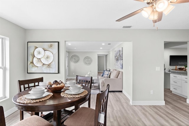 dining room featuring ceiling fan and light wood-type flooring