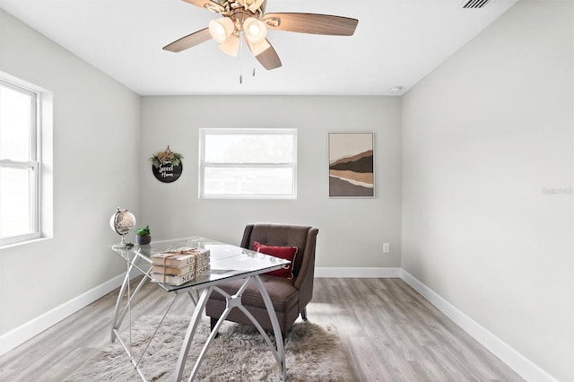 office with ceiling fan and light wood-type flooring