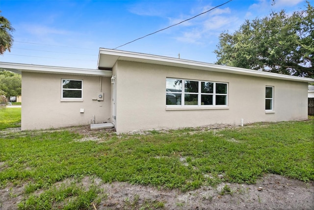 rear view of house with a yard