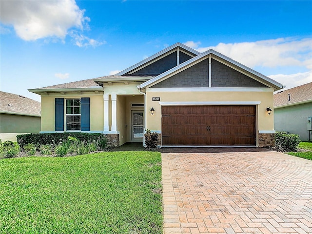 view of front of home with a garage and a front yard