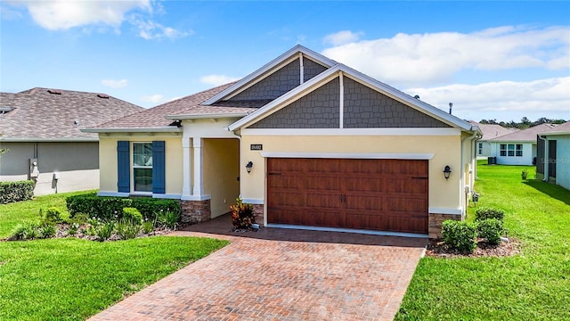 view of front of property with decorative driveway, stucco siding, a front yard, a garage, and stone siding