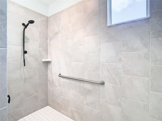 bathroom with a tile shower