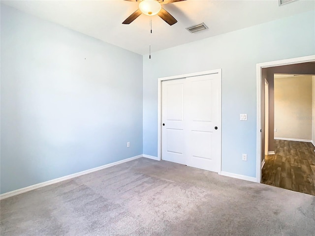 unfurnished bedroom featuring a closet, visible vents, baseboards, and carpet flooring