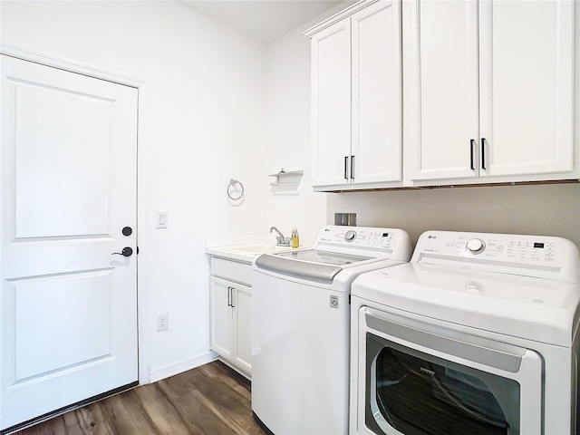 laundry area featuring a sink, baseboards, independent washer and dryer, cabinet space, and dark wood-style floors