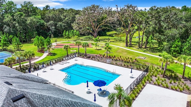 view of swimming pool with a yard and a patio