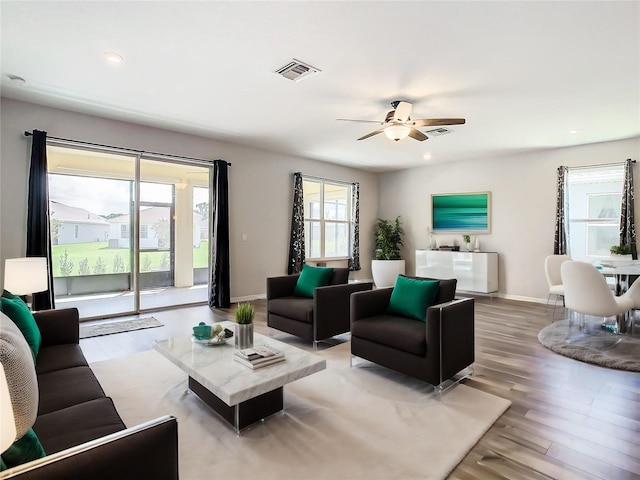 living room with wood-type flooring and ceiling fan