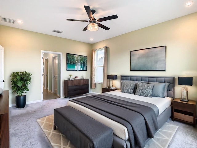 carpeted bedroom with ceiling fan, visible vents, and baseboards