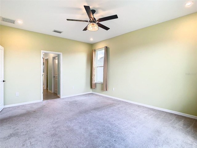 unfurnished room with ceiling fan and carpet floors