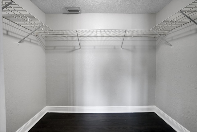 spacious closet featuring hardwood / wood-style flooring