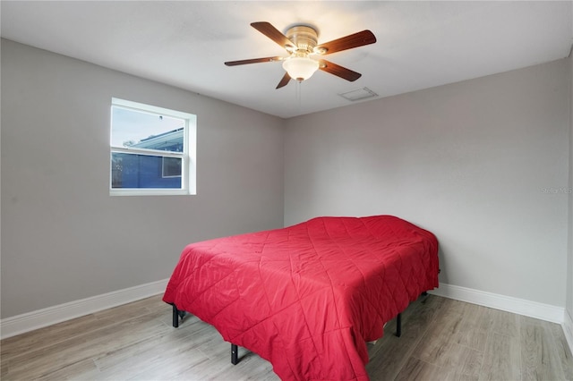 bedroom with ceiling fan and light wood-type flooring