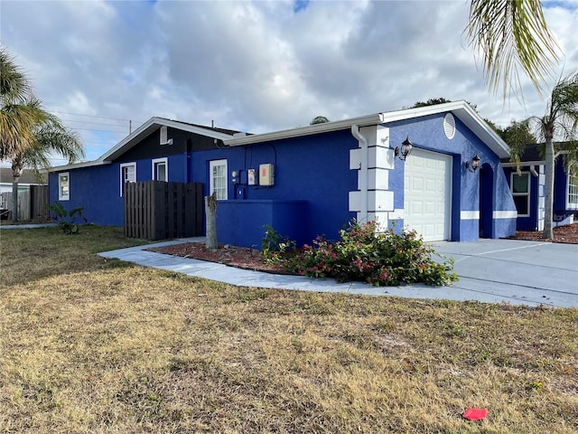 view of front of property with a garage and a front lawn