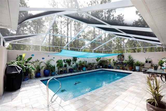 view of swimming pool with a patio area and glass enclosure