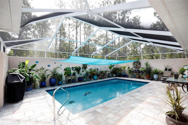 view of swimming pool with a patio area, glass enclosure, and a fenced in pool