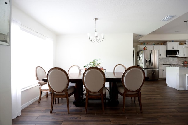 dining room featuring dark hardwood / wood-style floors and a notable chandelier