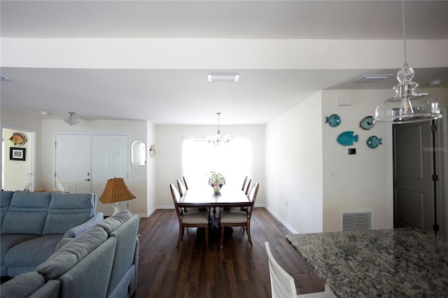 interior space with dark wood-type flooring and a notable chandelier