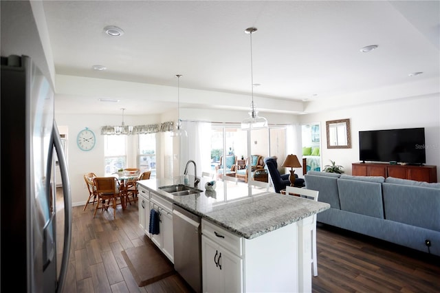 kitchen featuring dark hardwood / wood-style floors, appliances with stainless steel finishes, a kitchen island with sink, sink, and white cabinets