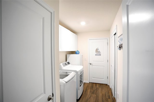 laundry area with cabinets, washer and clothes dryer, and dark hardwood / wood-style flooring