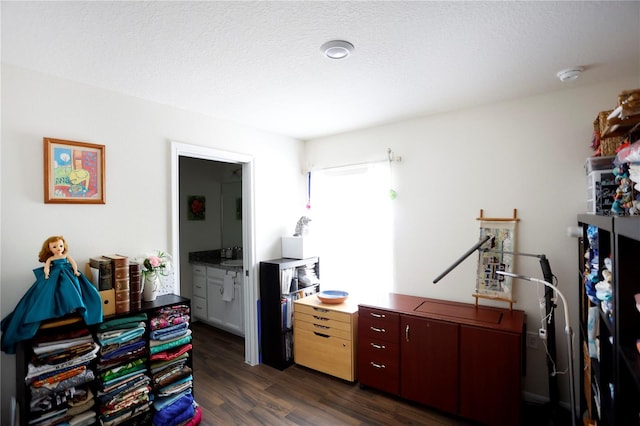 office area featuring a textured ceiling and dark wood-type flooring