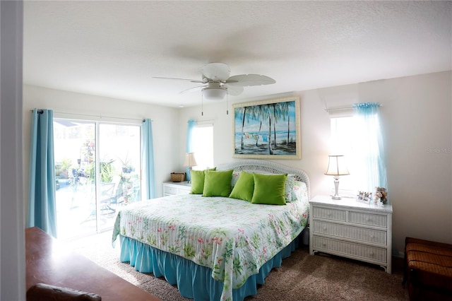 bedroom with dark carpet, multiple windows, ceiling fan, and access to outside