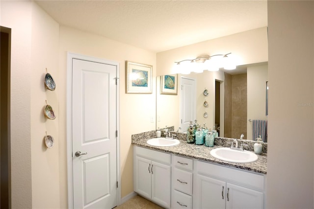 bathroom featuring vanity, toilet, and a textured ceiling