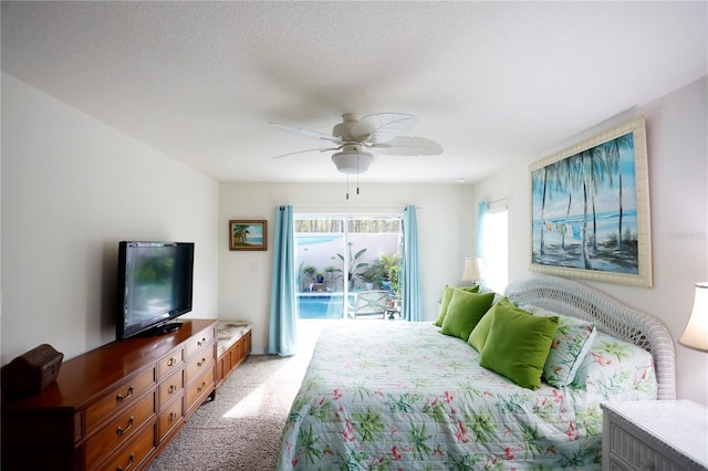 bedroom with ceiling fan, carpet, access to outside, and a textured ceiling