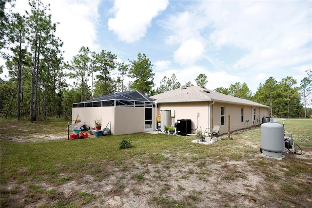 back of property featuring glass enclosure