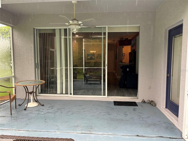 doorway to property featuring a patio area and ceiling fan