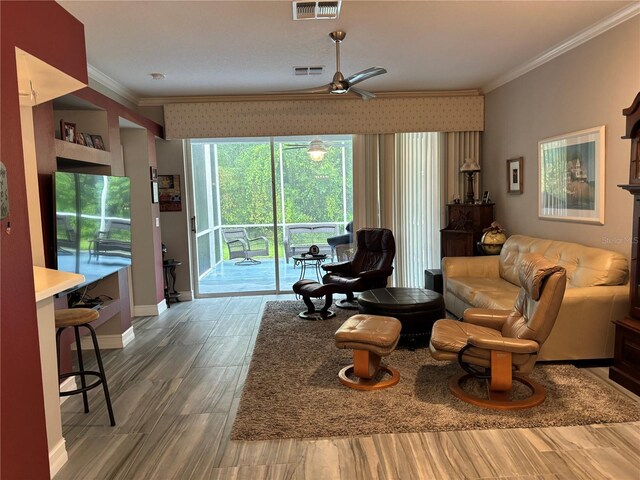 living room with crown molding, hardwood / wood-style flooring, and ceiling fan