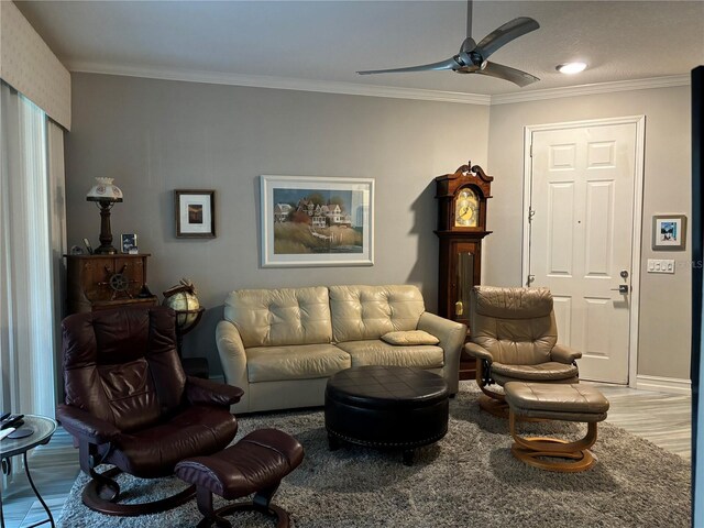 living room featuring crown molding, ceiling fan, and light hardwood / wood-style floors