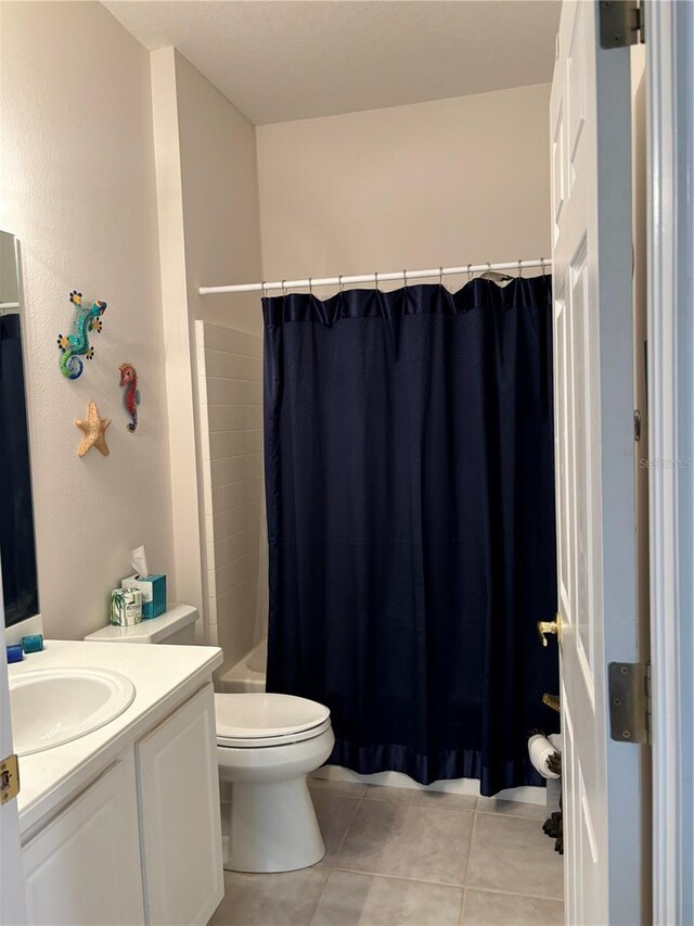 full bathroom featuring tile patterned flooring, vanity, toilet, and shower / bath combo