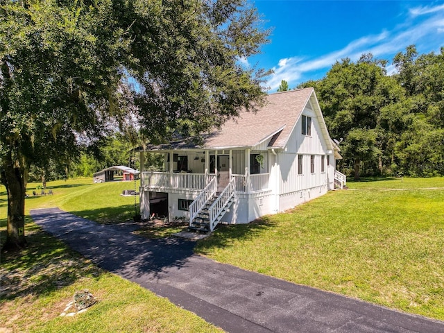 view of front of home with a front yard and a porch