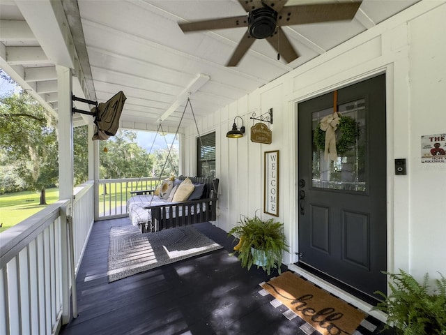 doorway to property with ceiling fan and covered porch