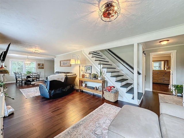 living room with dark hardwood / wood-style floors, crown molding, and a textured ceiling