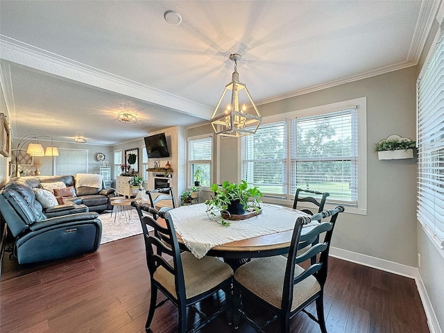 dining room featuring plenty of natural light, dark hardwood / wood-style floors, a notable chandelier, and ornamental molding