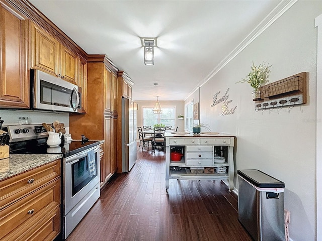 kitchen with crown molding, appliances with stainless steel finishes, dark hardwood / wood-style flooring, and light stone countertops