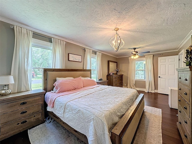 bedroom featuring ceiling fan with notable chandelier, ornamental molding, dark hardwood / wood-style flooring, and a textured ceiling