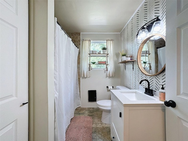 bathroom featuring vanity, toilet, and walk in shower