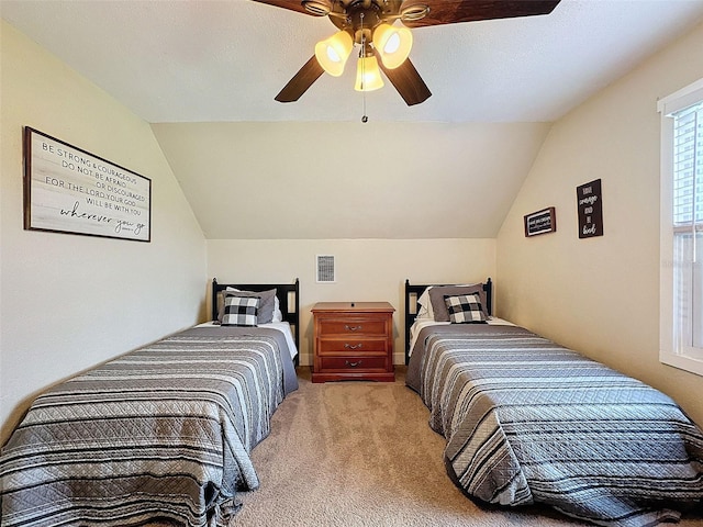 carpeted bedroom featuring vaulted ceiling and ceiling fan