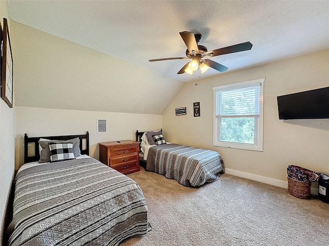 bedroom featuring lofted ceiling, ceiling fan, light colored carpet, and a textured ceiling