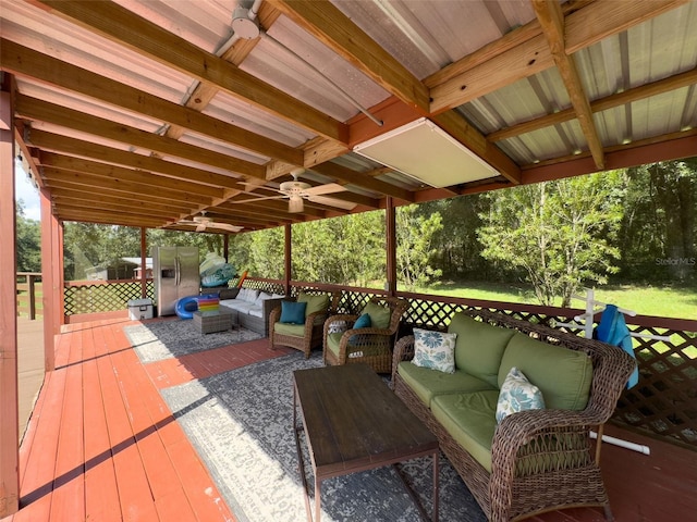 wooden terrace featuring an outdoor living space and ceiling fan