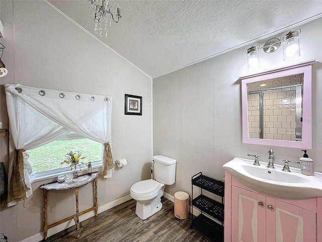 full bathroom with a textured ceiling, vanity, wood-type flooring, toilet, and lofted ceiling