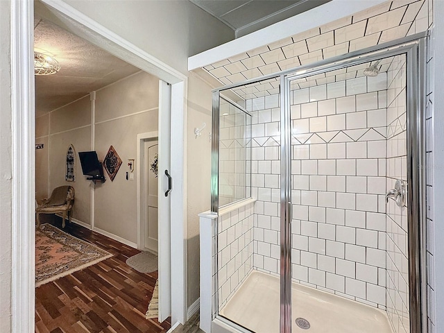 bathroom with walk in shower and hardwood / wood-style floors