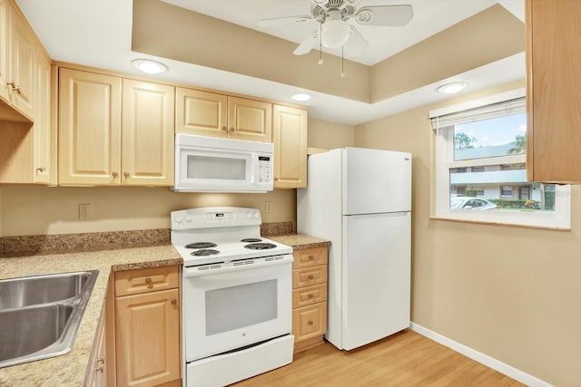 kitchen featuring white appliances, light hardwood / wood-style flooring, light brown cabinetry, and ceiling fan