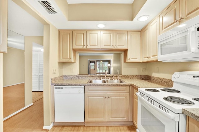 kitchen featuring sink, light brown cabinets, white appliances, and light hardwood / wood-style floors