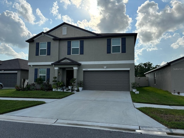 15434 Miller Creek Dr, Sun City Center, FL 33573 - view of front facade with stucco siding, an attached garage, concrete driveway, and a front lawn