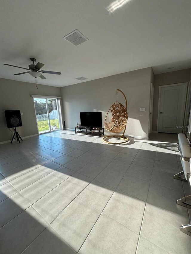 15434 Miller Creek Dr, Sun City Center, FL 33573 - unfurnished living room with tile patterned floors, a ceiling fan, visible vents, and baseboards