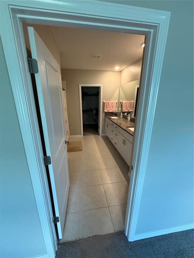 15434 Miller Creek Dr, Sun City Center, FL 33573 - bathroom featuring tile patterned flooring, double vanity, and visible vents
