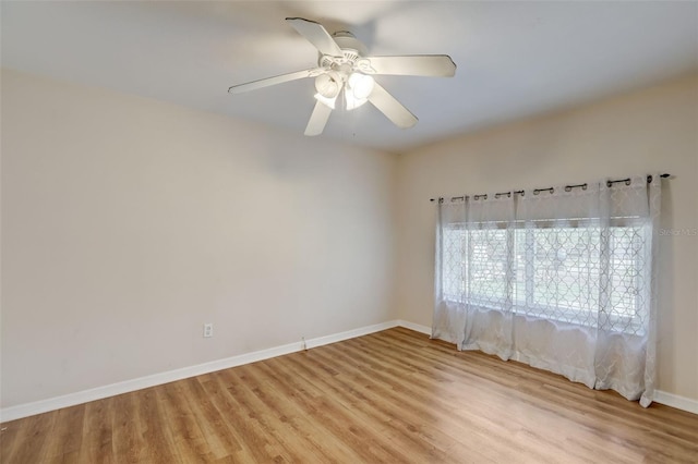 empty room with ceiling fan and light hardwood / wood-style flooring