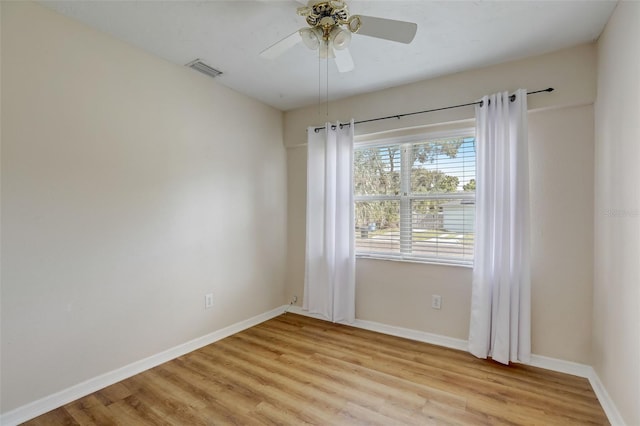 empty room featuring ceiling fan and light hardwood / wood-style flooring