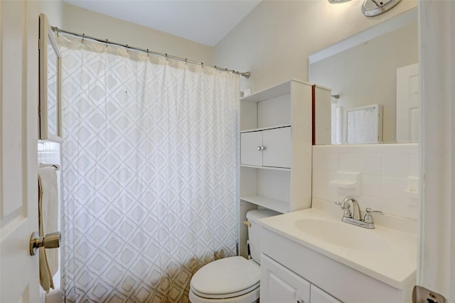 bathroom featuring backsplash, vanity, toilet, and walk in shower